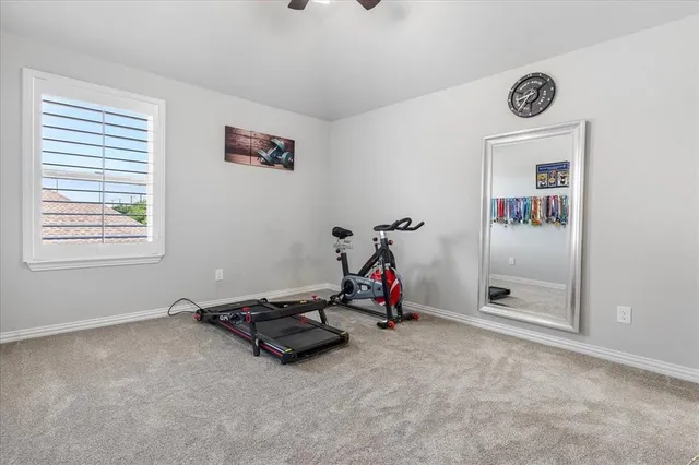 a room with gym equipment and a large window