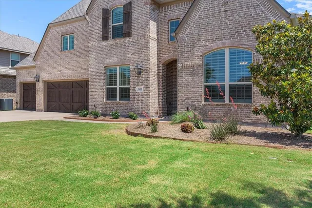 a view of a house with a yard and sitting area