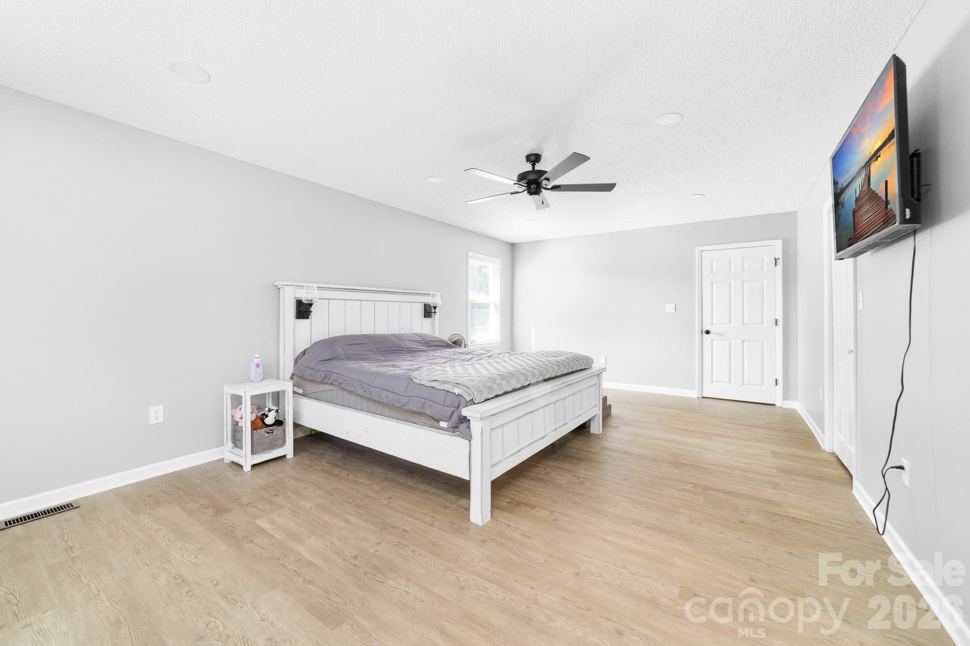 248 Jack McKinney Road Forest City, NC 28043 - Photo 14 of 29 a bedroom with a bed and a flat screen tv