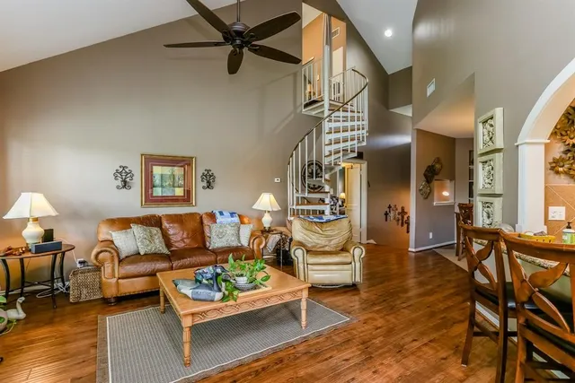 a living room with furniture and a wooden floor