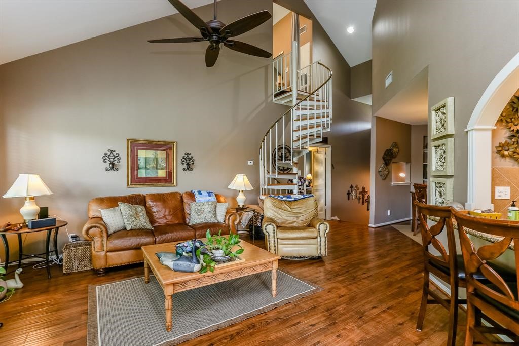 4144 Greystone Way, Unit 306 Sugar Land, TX 77479 - Photo 1 of 11 a living room with furniture and a wooden floor