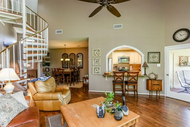 a living room with furniture and wooden floor