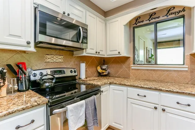 a kitchen with a stove and a microwave