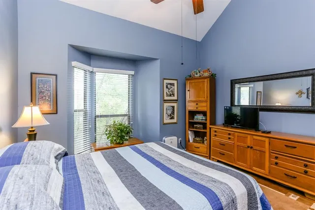 a bedroom with a bed and a flat screen television