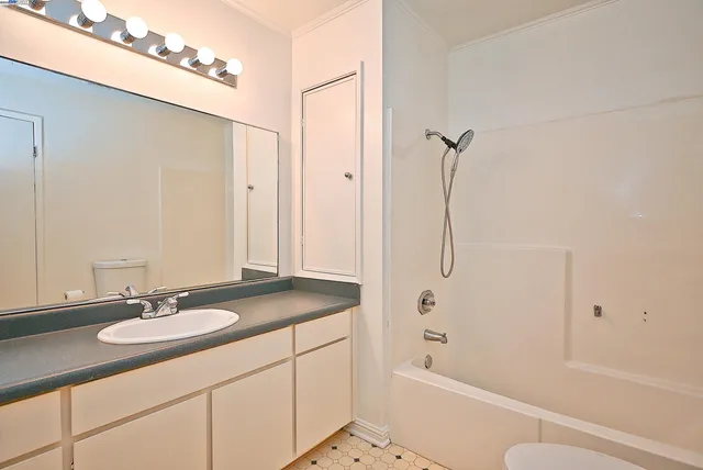 a bathroom with a sink a toilet and a mirror