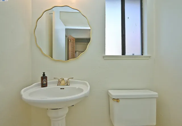 a kitchen with stainless steel appliances white cabinets and a stove top oven