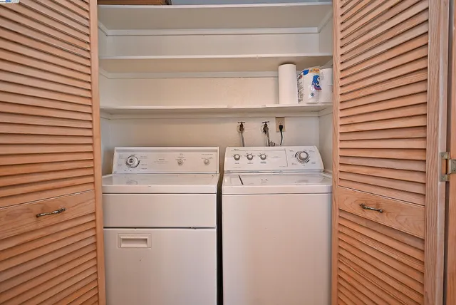 a view of a balcony with wooden floor and fence