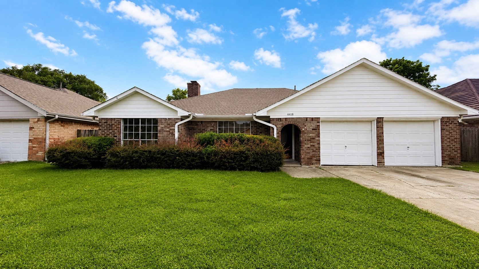 4418 Ponca Street Pasadena, TX 77504 - Photo 1 of 23 Clean brick curb appeal with a front lawn, wide drive, and two-car garage. (image has been enhance for marketing purposes)