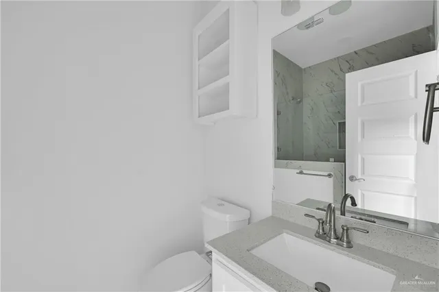 a bathroom with a sink a toilet and a mirror