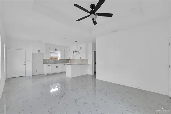 a view of kitchen with stainless steel appliances cabinets and a ceiling fan