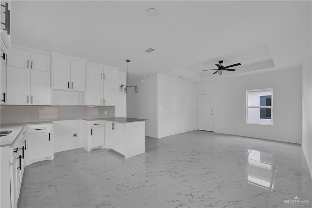 11403 North 25th Street, Unit 2 McAllen, TX 78504 - Photo 4 of 14 a kitchen with white cabinets and window