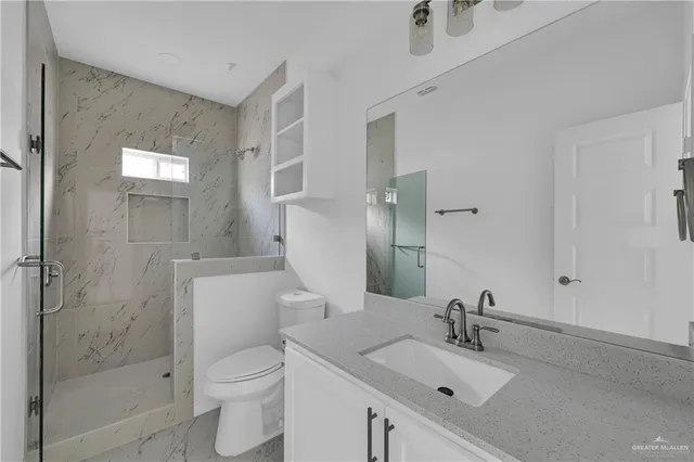 a bathroom with a sink toilet and shower