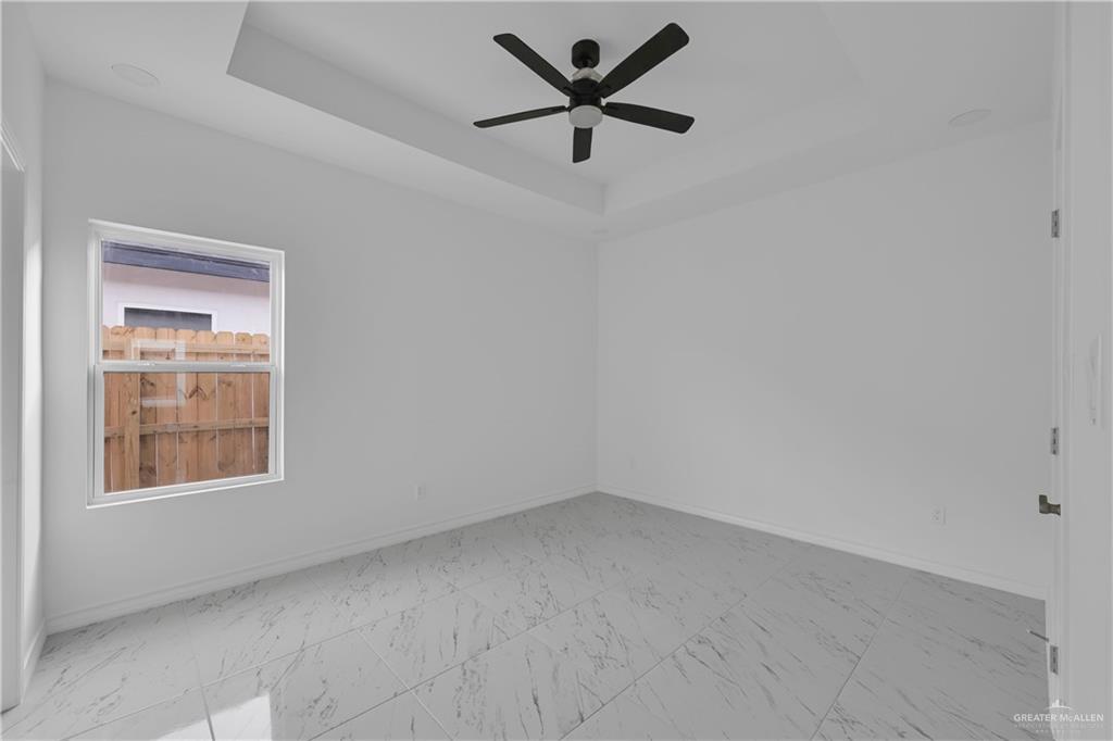 11403 North 25th Street, Unit 2 McAllen, TX 78504 - Photo 10 of 14 an empty room with a window and a fan