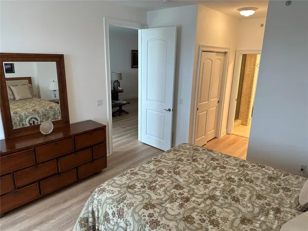 a bedroom with a bed and a dresser in it
