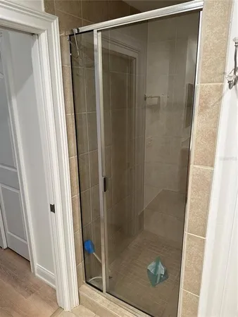 a bathroom with a glass door shower