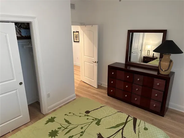 a bedroom with a bed and a dresser in it