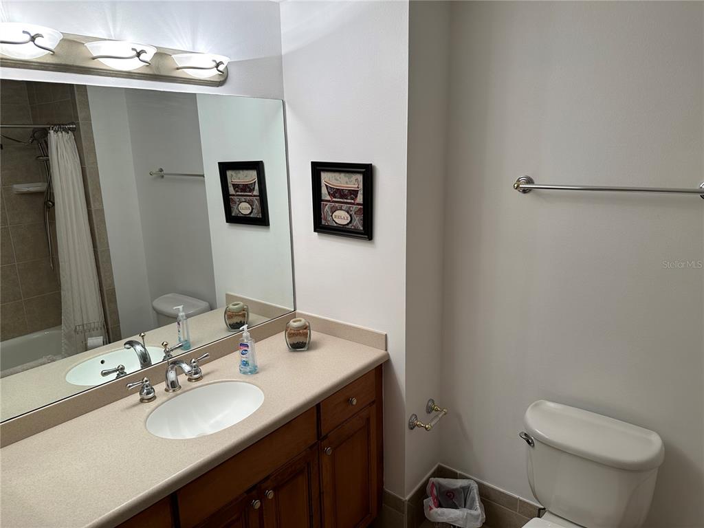 615 Riviera Dunes Way, Unit 406 Palmetto, FL 34221 - Photo 19 of 28 a bathroom with a sink toilet and a mirror