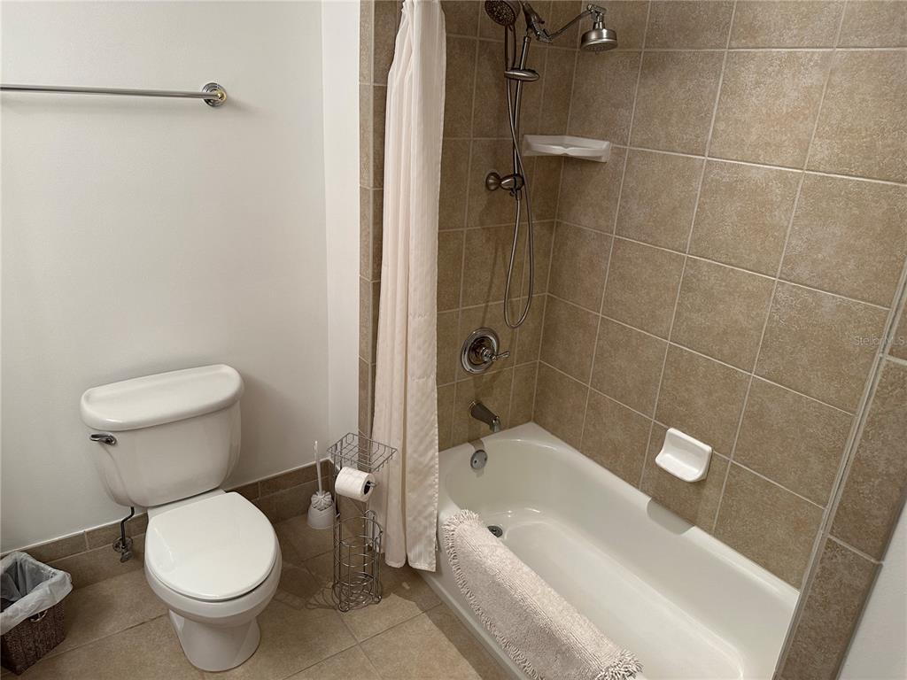 615 Riviera Dunes Way, Unit 406 Palmetto, FL 34221 - Photo 20 of 28 a white toilet sitting next to a bath tub and shower