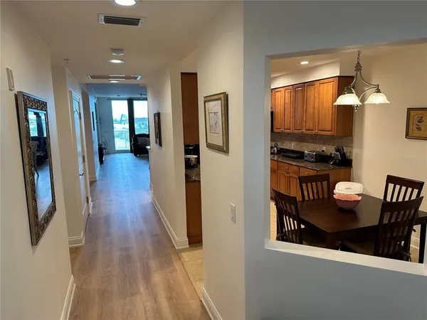 a hallway with dining table and chairs