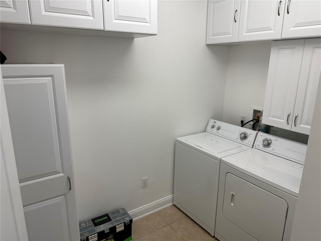 615 Riviera Dunes Way, Unit 406 Palmetto, FL 34221 - Photo 21 of 28 a utility room with dryer and washer