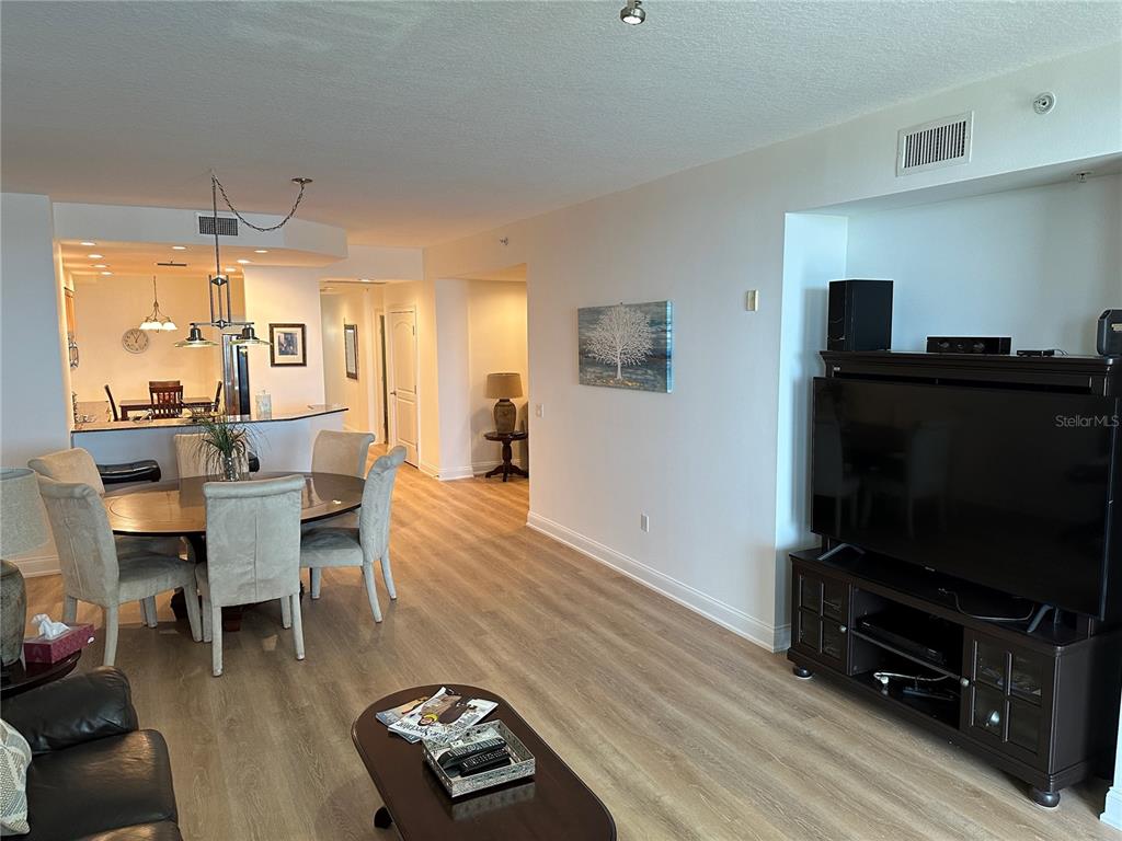 615 Riviera Dunes Way, Unit 406 Palmetto, FL 34221 - Photo 8 of 28 a living room with furniture and a flat screen tv