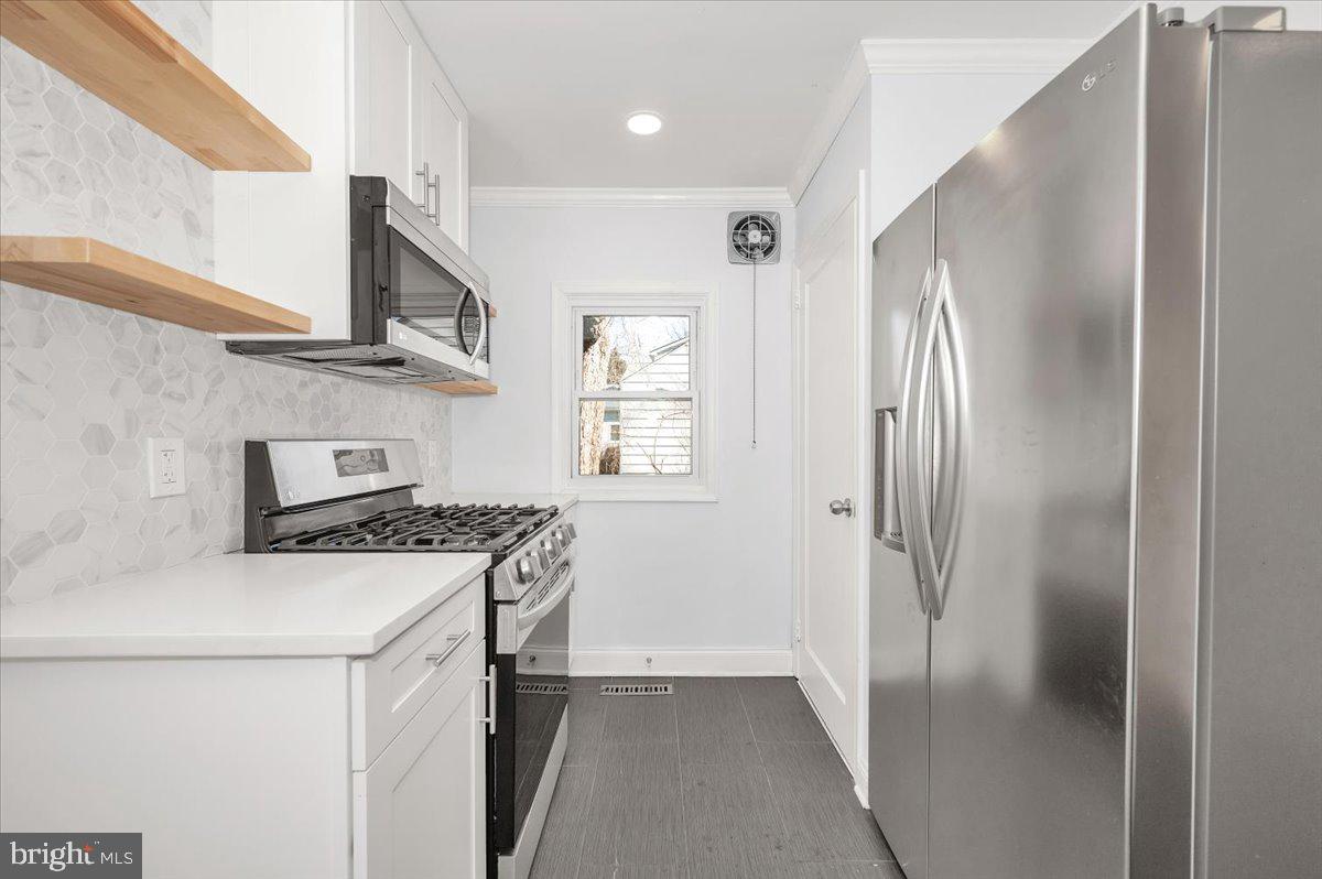 4511 Bennion Road Silver Spring, MD 20906 - Photo 12 of 40 a kitchen with stainless steel appliances granite countertop a refrigerator a sink and a stove