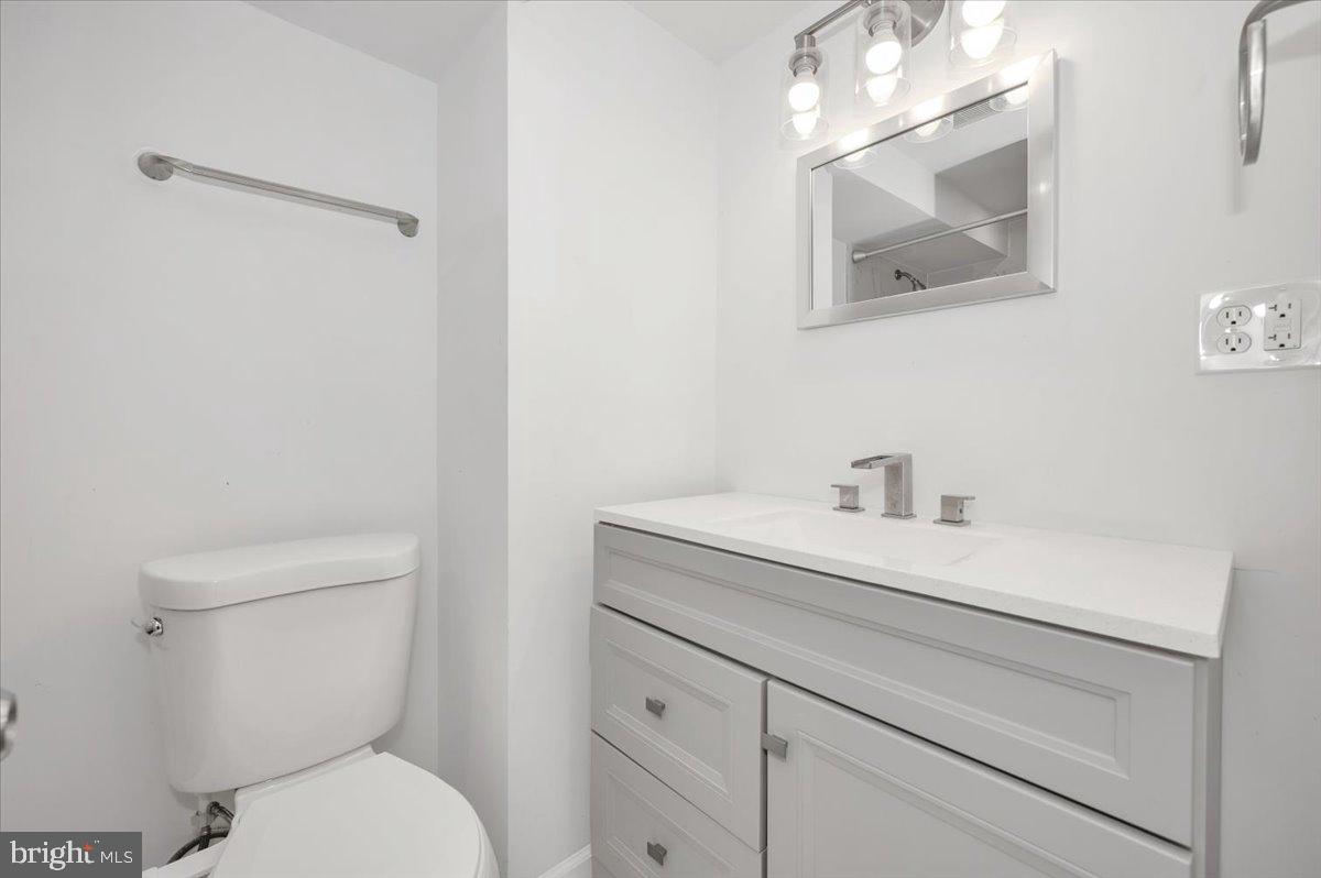 4511 Bennion Road Silver Spring, MD 20906 - Photo 29 of 40 a bathroom with a toilet sink and mirror