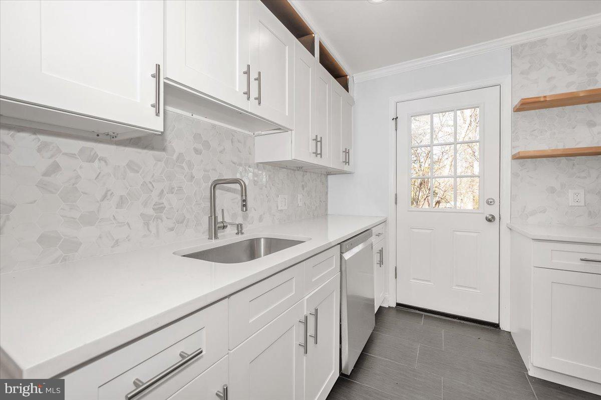 4511 Bennion Road Silver Spring, MD 20906 - Photo 9 of 40 a kitchen with sink cabinets and window