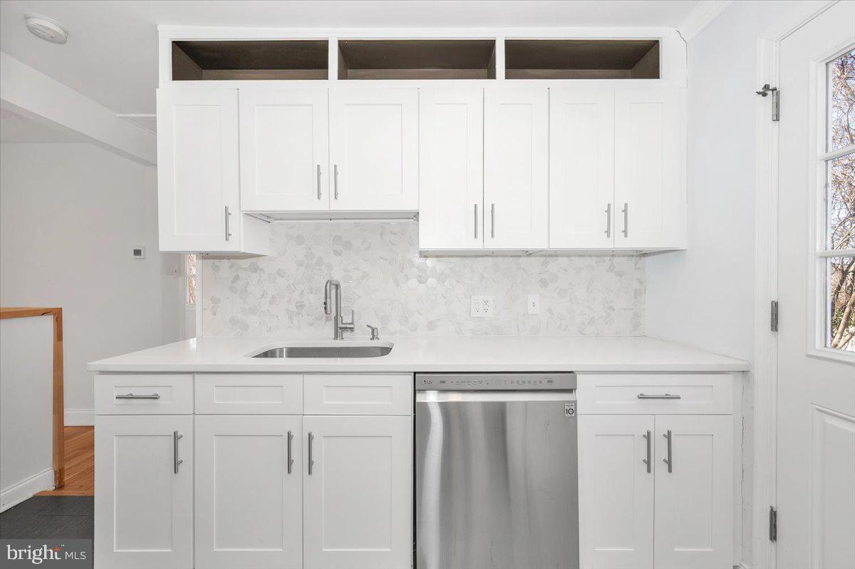 4511 Bennion Road Silver Spring, MD 20906 - Photo 10 of 40 a kitchen with white cabinets and window