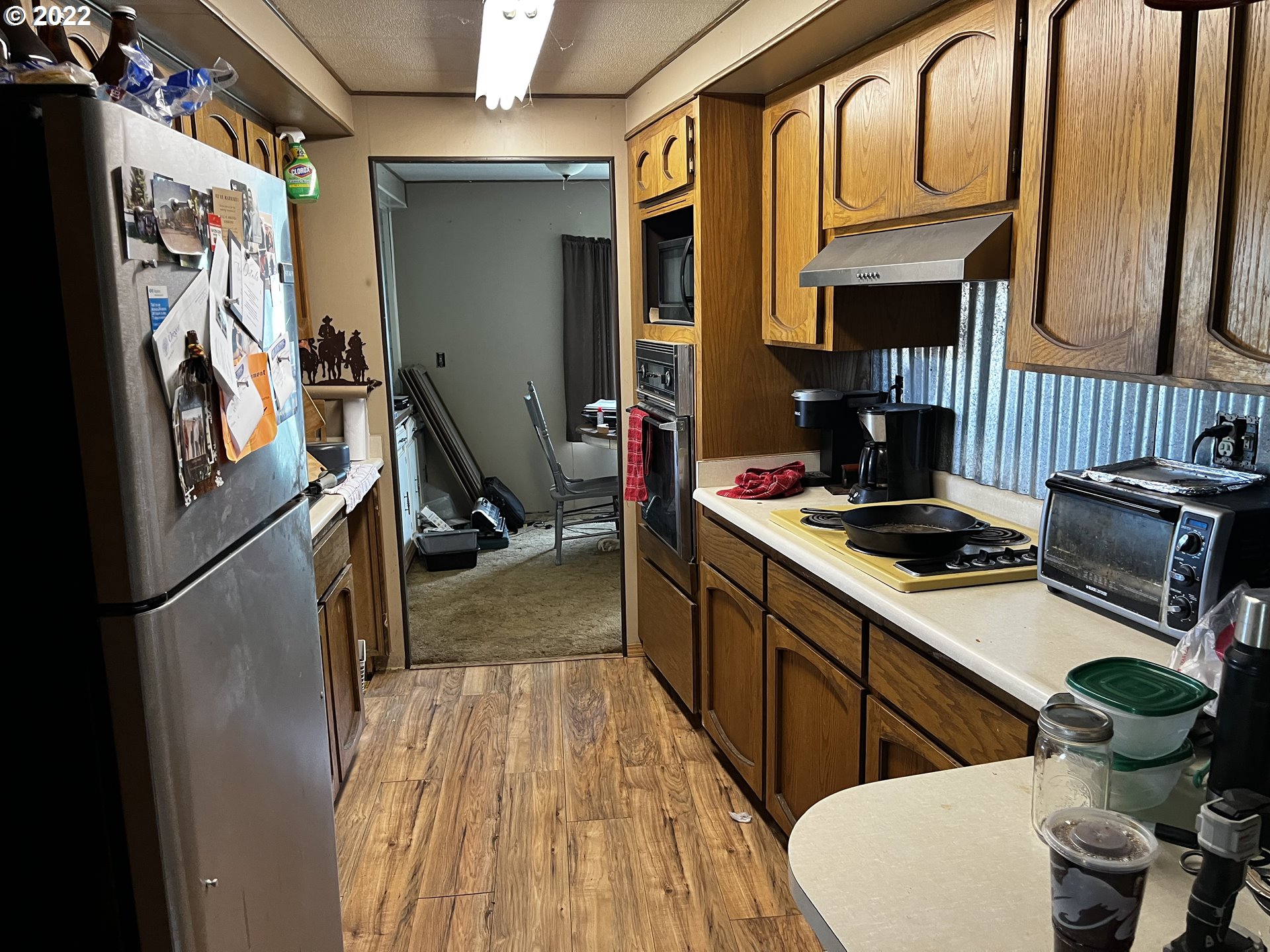 911 East Punkin Center Road Hermiston, OR 97838 - Photo 5 of 12 a kitchen with a sink appliances and cabinets