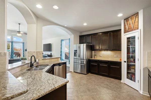 a kitchen with refrigerator cabinets and furniture