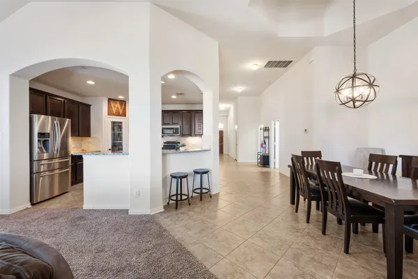 a view of a dining area with furniture kitchen and chandelier