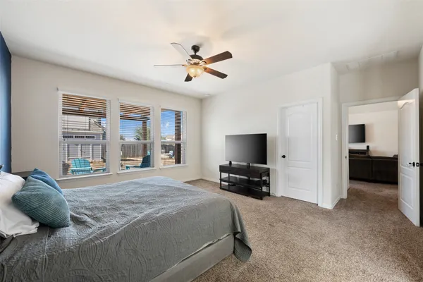 a bedroom with a bed and a television