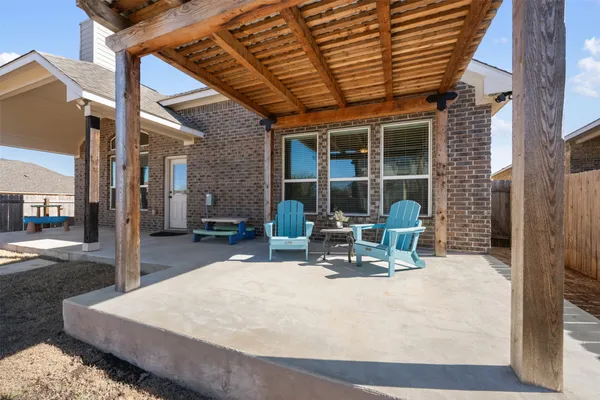 a backyard view with a seating space