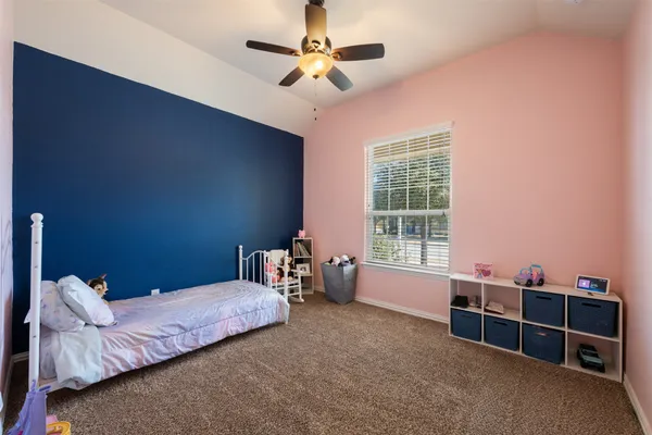 a bedroom with furniture and a window