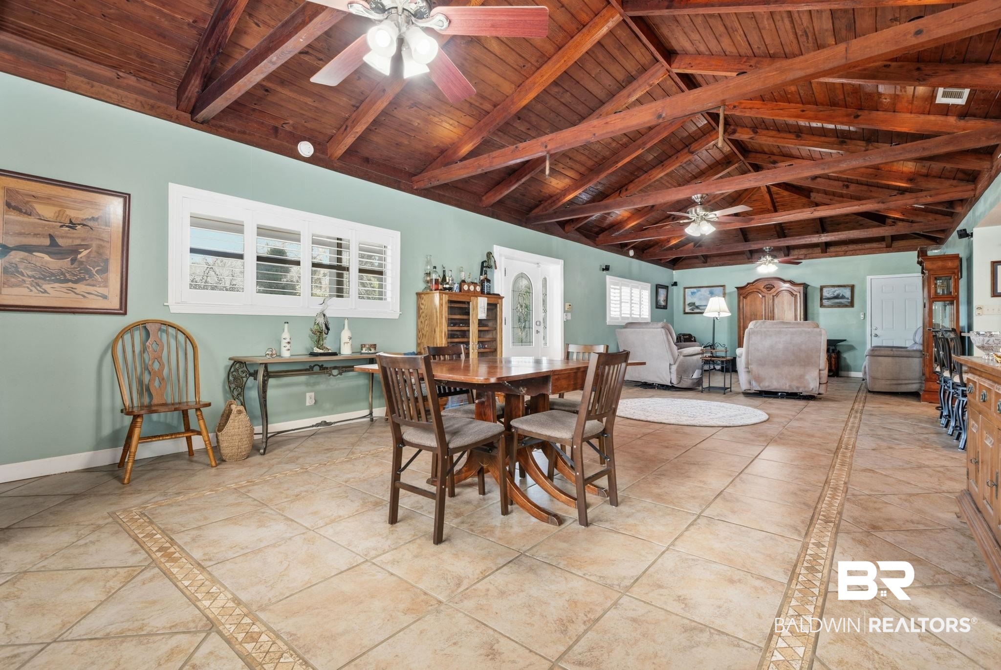 15025 Bellingrath Road Coden, AL 36523 - Photo 41 of 79 Dining space with a ceiling fan, inlaid floor details, and a wood ceiling with exposed beams