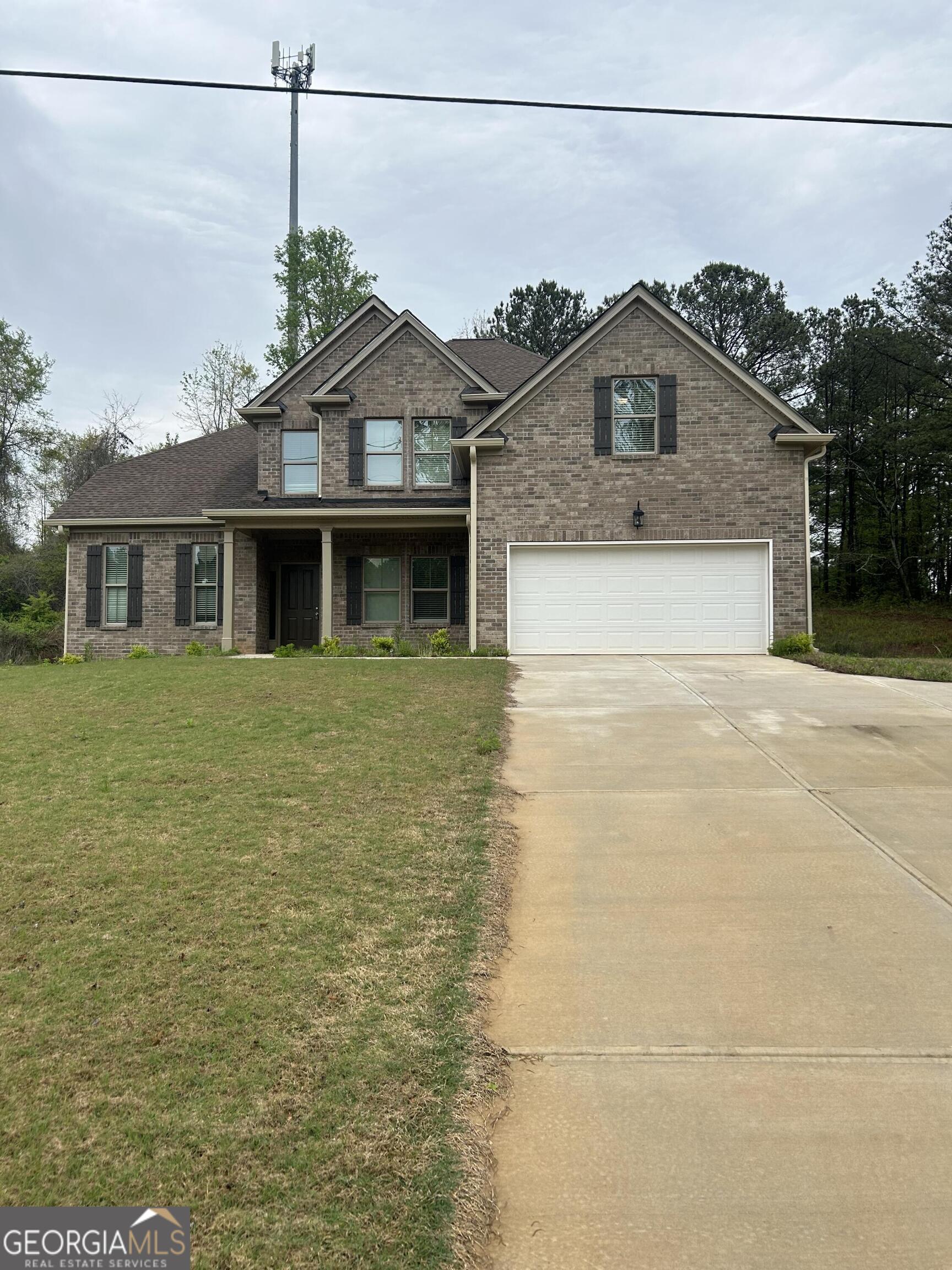 606 Gardner Road Stockbridge, GA 30281 - Photo 1 of 1 a view of a white house next to a yard with a palm trees