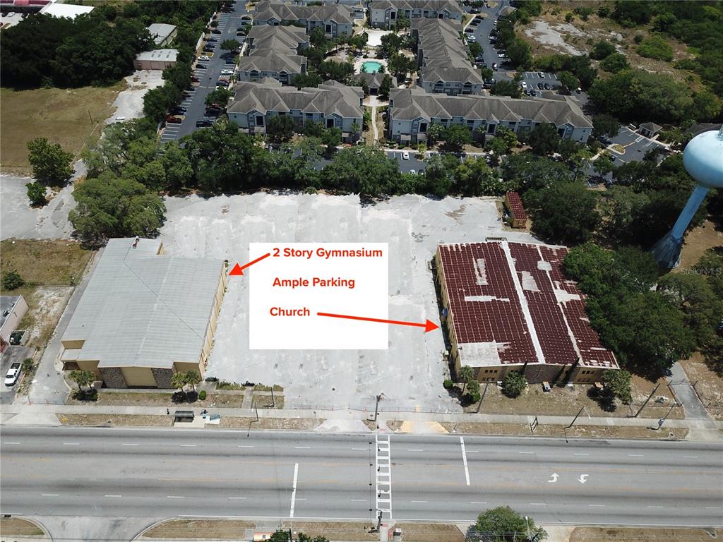 2425 North Hiawassee Road Orlando, FL 32818 - Photo 10 of 10 an aerial view of a multi story residential apartment building with garage and large trees
