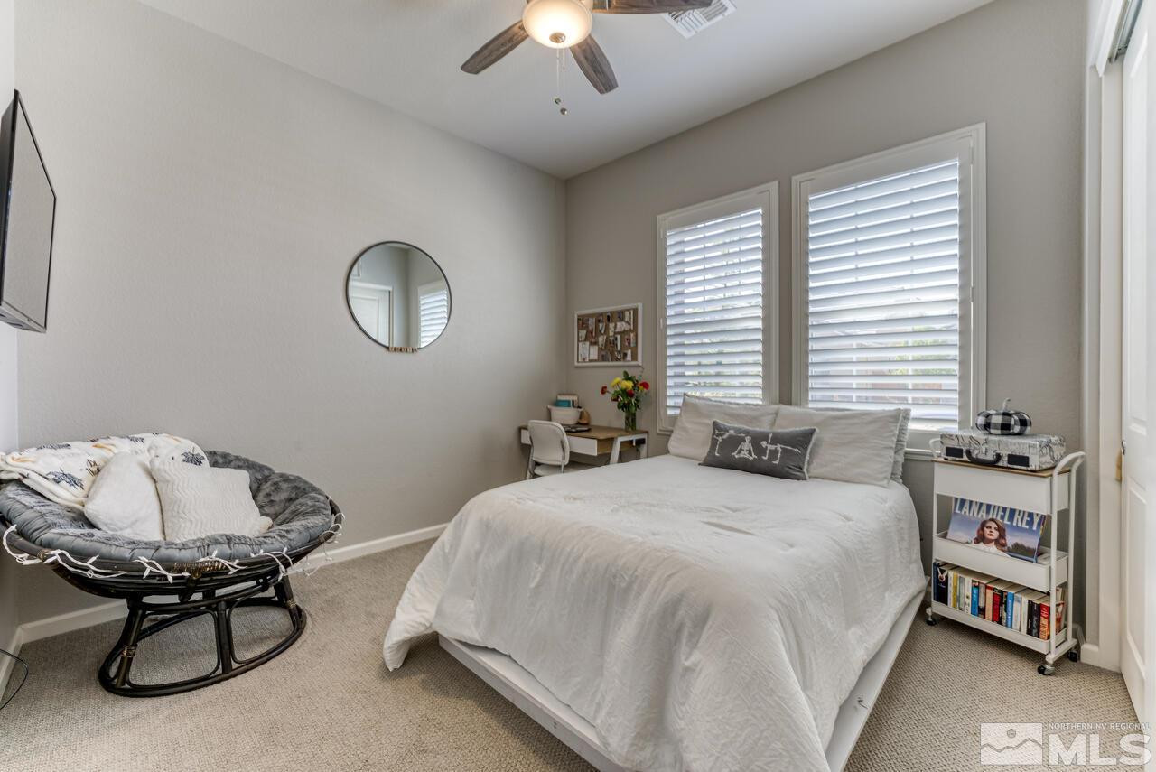 9450 Baldacci Road Reno, NV 89521 - Photo 5 of 40 a bedroom with a bed and a chandelier
