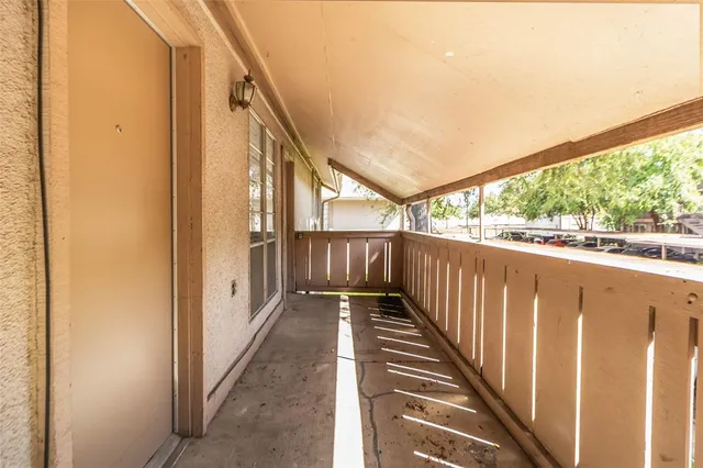 a view of a balcony with wooden floor