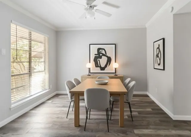 a view of a dining room with furniture window and wooden floor