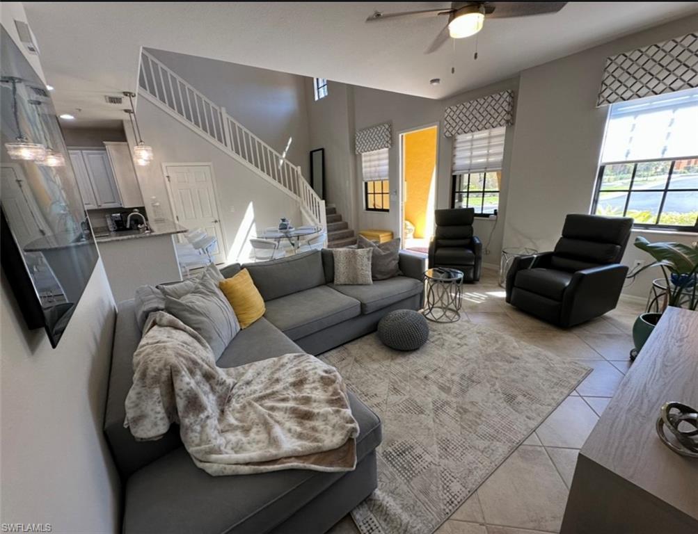 8997 Cambria Circle, Unit 2001 Naples, FL 34113 - Photo 11 of 42 Living area featuring baseboards, ceiling fan, stairway, and light tile patterned floors