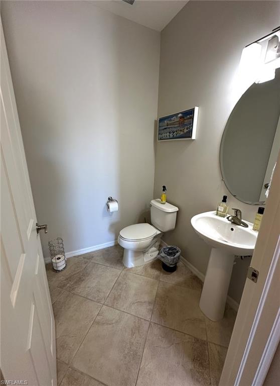 8997 Cambria Circle, Unit 2001 Naples, FL 34113 - Photo 12 of 42 Half bath featuring baseboards, toilet, and a sink