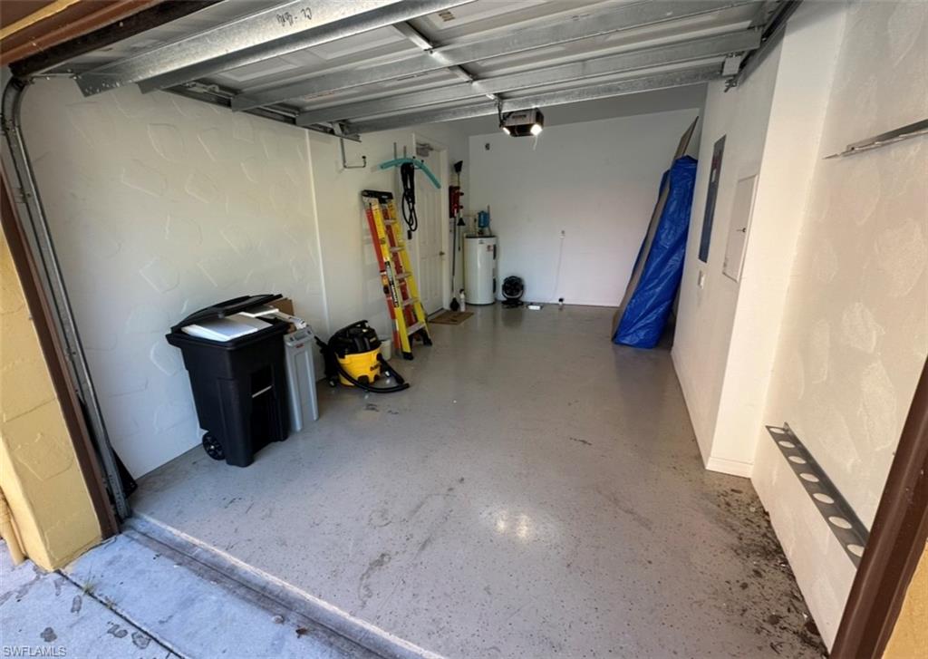 8997 Cambria Circle, Unit 2001 Naples, FL 34113 - Photo 21 of 42 Garage featuring gas water heater and a garage door opener