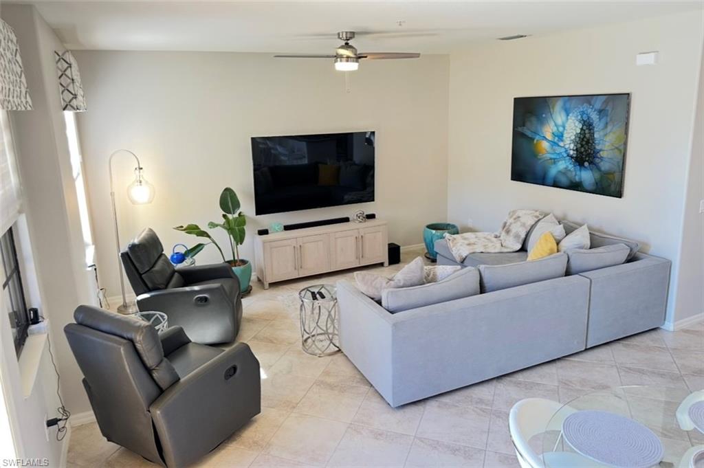 8997 Cambria Circle, Unit 2001 Naples, FL 34113 - Photo 4 of 42 Living area featuring baseboards, ceiling fan, and light tile patterned floors