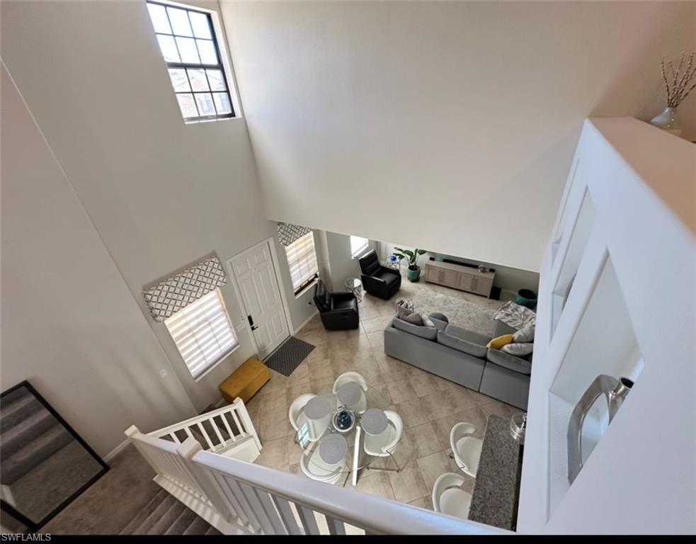 8997 Cambria Circle, Unit 2001 Naples, FL 34113 - Photo 9 of 42 Tiled living room with a high ceiling