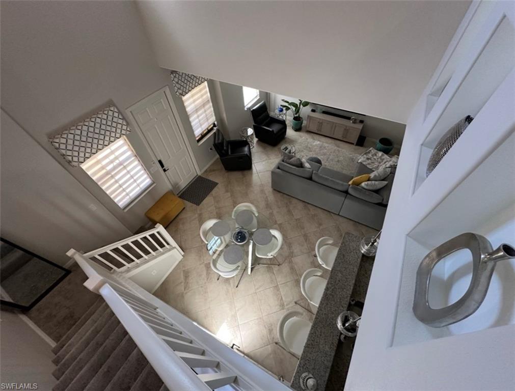 8997 Cambria Circle, Unit 2001 Naples, FL 34113 - Photo 10 of 42 Living area with a towering ceiling and tile patterned flooring