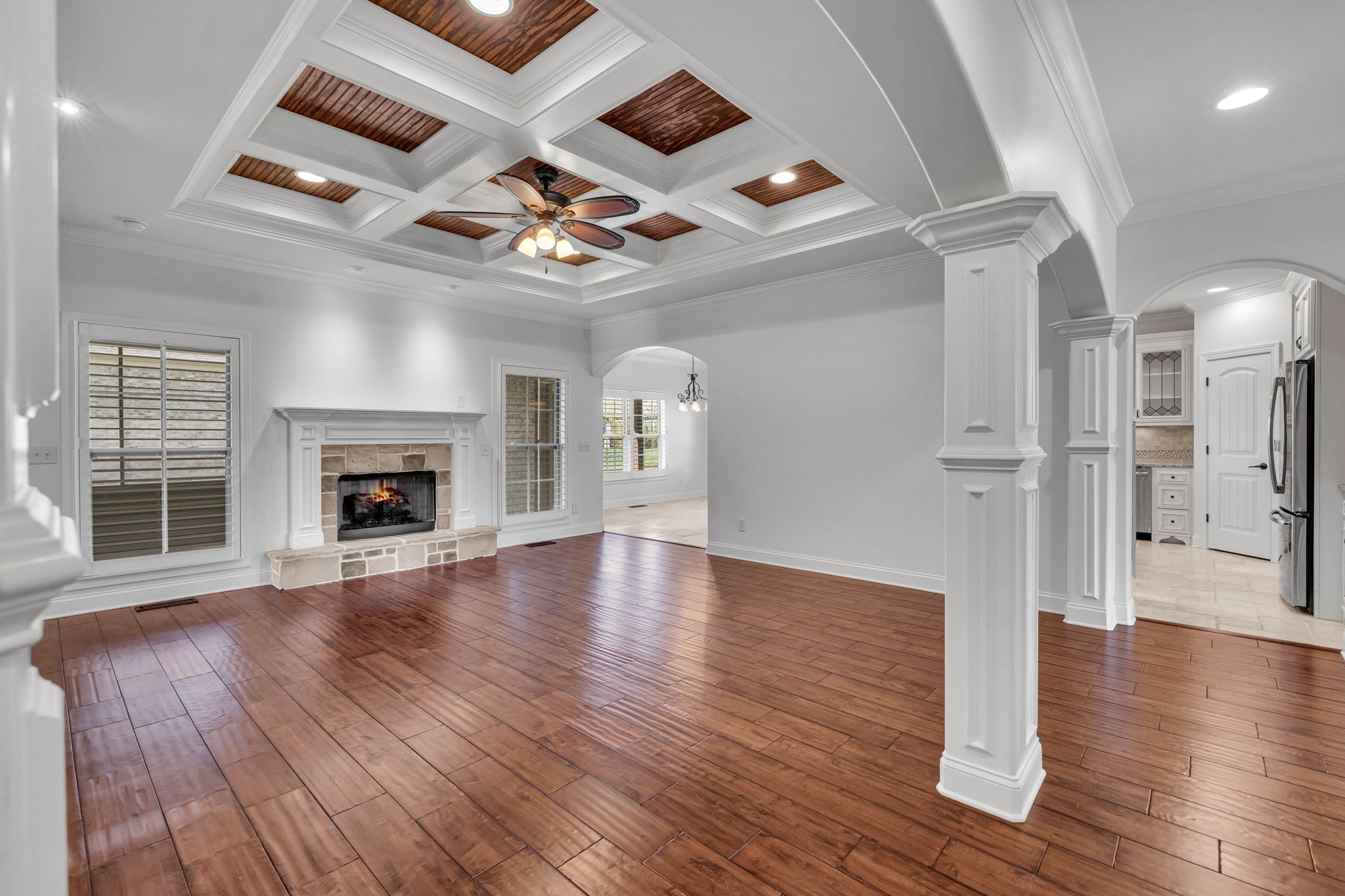 2065 Autumn Ridge Way Spring Hill, TN 37174 - Photo 31 of 58 an empty room with wooden floor a ceiling fan a fireplace and windows