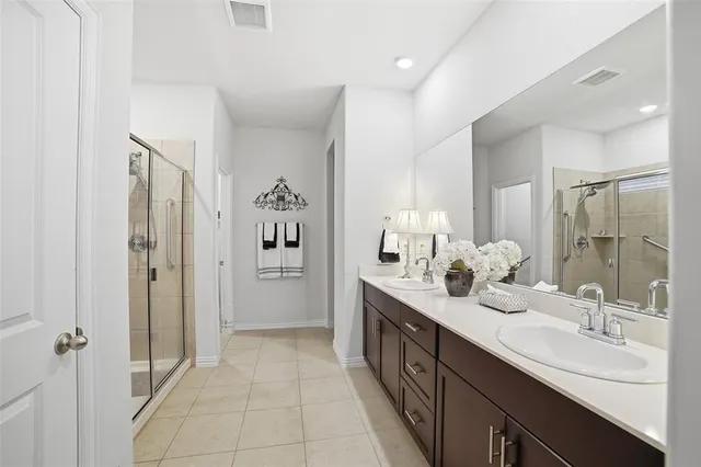 a spacious bathroom with a double vanity sink mirror and double