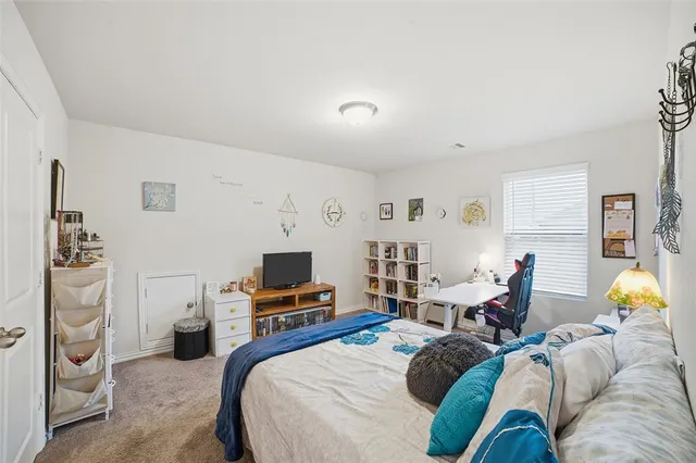 a bedroom with furniture and a flat screen tv